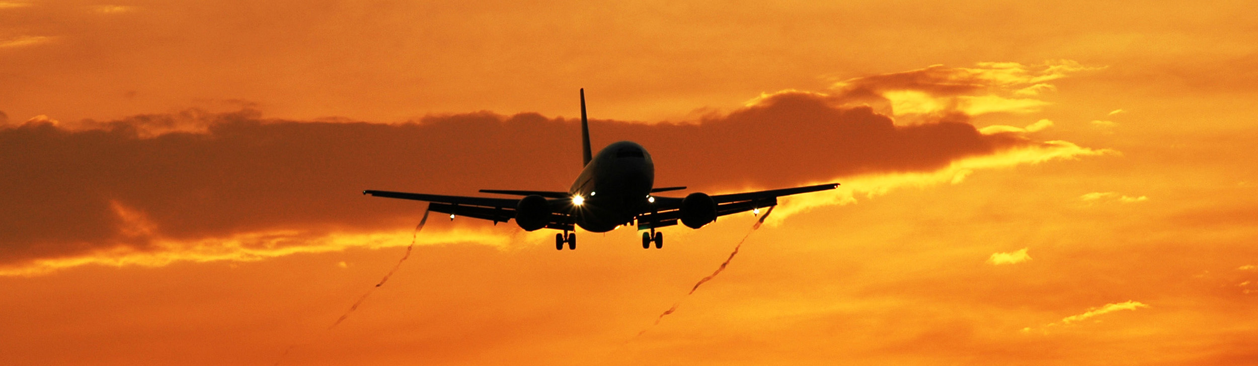 Airplane approach during sunset